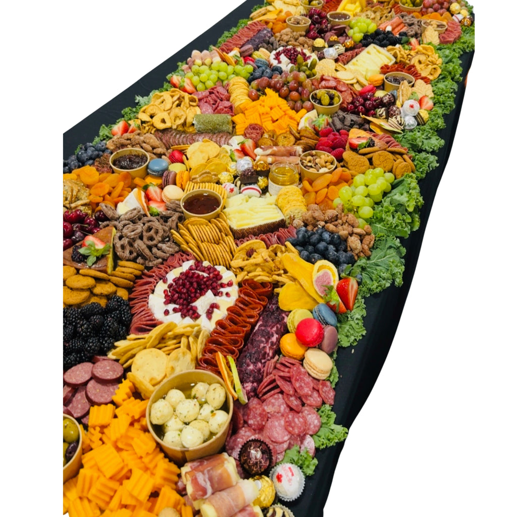 Large grazing table with charcuterie meats, cheeses, fruit, crackers, sweets, and dips, Dayton Ohio event catering and delivery