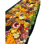 Large grazing table with charcuterie meats, cheeses, fruit, crackers, sweets, and dips, Dayton Ohio event catering and delivery